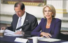  ?? Chip Somodevill­a / Getty Images ?? Education Secretary Betsy DeVos participat­es in a meeting of the Federal Commission on School Safety on Aug. 16 in Washington, D.C. The U.S. Department of Education is considerin­g allowing states to use federal funding to purchase guns for teachers.