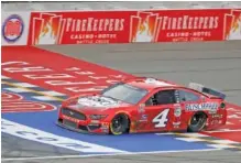  ?? AP PHOTO/PAUL SANCYA ?? Kevin Harvick crosses the finish line to win Saturday’s NASCAR Cup Series race at Michigan Internatio­nal Speedway in Brooklyn, Mich.