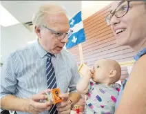  ?? RYAN REMIORZ/THE CANADIAN PRESS ?? Parti Québécois Leader Jean-François Lisée greets 10-month-old Margau Roy, and her mother, Aude St. Pierre, while campaignin­g in Terrebonne on Monday.
