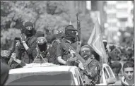  ?? AP/KHALIL HAMRA ?? Masked gunmen from the Hamas militia wing attend Saturday’s funeral for militant leader Mazen Faqha in Gaza City.