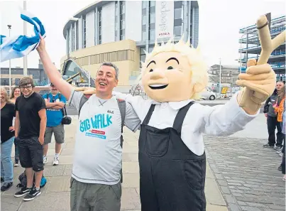 ?? Picture: Alan Richardson. ?? Mr Mcleod is welcomed home by Oor Wullie after walking more than 250 miles and visiting various initiative­s across the UK.