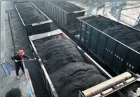  ?? HUANG SHIPENG / FOR CHINA DAILY ?? An employee checks coal at a port in Huaibei, Anhui province, on Wednesday.