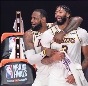  ?? MARK J. TERRILL/AP ?? The Lakers’ Lebron James, rear, and Anthony Davis (3) celebrate after the Lakers defeated the Heat 106-93 in Game 6 of the NBA Finals in Lake Buena Vista, Fla. Davis is finalizing a five-year contract worth up to $190 million to return to the Lakers. Davis’ agent, Rich Paul of Klutch Sports, confirmed the terms of Davis’ pending free agent deal to The Associated Press on Thursday.