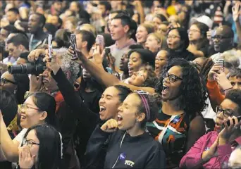  ?? Rebecca Droke/Post-Gazette ?? The crowd reacts Wednesday as first lady Michelle Obama walks on stage as she stumps for Democratic presidenti­al candidate Hillary Clinton at the University of Pittsburgh.