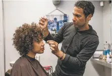  ?? Nick Otto / Special to The Chronicle ?? On the same day SB188 was signed into law, Fritz Clay works on Sherri McMullen’s hair at the Hair Play Salon in S.F.