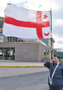  ?? PHOTOS BY CADET WARRANT OFFICER 2ND CLASS CHARLIE CHAFE ?? Cadet Warrant Officer 2nd Class Jolie Jedorre marches with the Mi’kmaw flag as she takes part in a Remembranc­e Day ceremony. Jedorre lives on reserve in Eskasoni and will be leading her Royal Canadian Air Cadet Squadron 29 Sydney Kiwanis at the ceremony in Membertou Nov. 11.