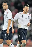  ?? ?? Looking the other way: Rio Ferdinand (left) and John Terry in action for England