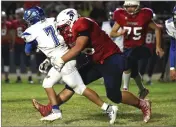  ?? RECORDER PHOTO BY CHIEKO HARA ?? Strathmore High School’s Lucas Raya, right, takes down Avenal runner Friday during the first half at Spartan Stadium in Strathmore.