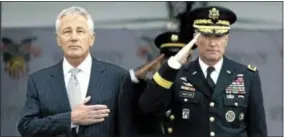  ?? AP PHOTO/ MIKE GROLL ?? Defense Secretary Chuck Hagel, left, and Superinten­dent Lt. Gen. David Huntoon, Jr., stand for the national anthem during a graduation and commission­ing ceremony at the U. S. Military Academy in West Point on Saturday.