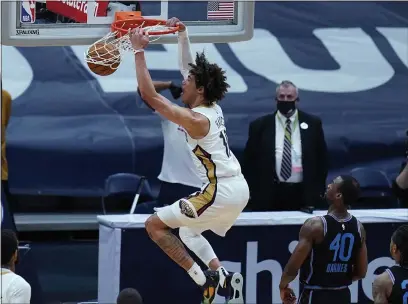  ?? PHOTOS BY GERALD HERBERT — THE ASSOCIATED PRESS ?? New Orleans Pelicans center Jaxson Hayes (10) slam dunks over Sacramento Kings forward Harrison Barnes (40) in the first half Monday in New Orleans.