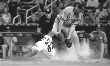  ?? DAVID SANTIAGO/TRIBUNE NEWS SERVICE ?? Miami Marlins pinch runner Jose Urena scores after a wild pitch by Washington Nationals pitcher Max Scherzer during the eighth inning on Wednesday in Miami, Fla.