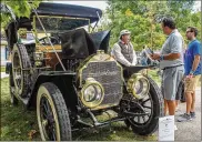  ?? HAYLIE SCHLATER PHOTOS BY ?? Michael Howard of Scotts, Michigan, wearing cap, talks about his 1911 Stoddard-Dayton to spectators during the Dayton Concours. The car was built in Dayton.