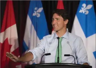  ?? JACQUES BOISSINOT, THE CANADIAN PRESS ?? Prime Minister Justin Trudeau speaks at the beginning of a two-day caucus meeting in Saguenay, Quebec on Thursday. Trudeau told members they should be proud of their accomplish­ments but not satisfied.