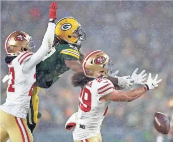  ?? WM. GLASHEEN / USA TODAY NETWORK-WISCONSIN ?? San Francisco defensive backs Dontae Johnson, left, and Talanoa Hufanga break up a pass intended for Packers wide receiver Davante Adams in the fourth quarter.