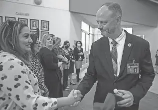  ?? CORRIE BOUDREAUX/EL PASO MATTERS FILE ?? Nate Carman greets an attendee at the reception honoring his hire as the next Socorro ISD superinten­dent in 2022. The school board voted 6-0 Monday to place Carman on administra­tive leave with pay.