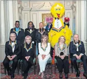  ?? WOLF/ THE ASSOCIATED PRESS] ?? Front row from left, 2019 Kennedy Center Honorees Michael Tilson Thomas, Linda Ronstadt, Sally Field, Joan Ganz Cooney, and Lloyd Morrisett, back row from left, Philip Bailey, Verdine White, Ralph Johnson, and characters from “Sesame Street,” Abby Cadabby, Big Bird, and Elmo pose for a group photo following the Kennedy Center Honors State Department Dinner at the State Department on Saturday in Washington. [KEVIN