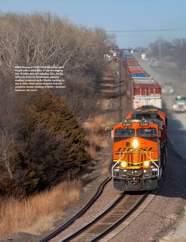  ?? Mike Martin ?? BNSF Railway ES44AC No. 6386 glides westbound with a stack train in tow at milepost 164, 10 miles west of Cassoday, Kan., on the railroad’s Emporia Subdivisio­n, passing roadbed constructi­on for double tracking on Jan. 9, 2020. Work on the Emporia Sub will complete double tracking of BNSF’s Southern Transcon.