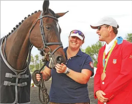  ?? CHRIS BARBER — DIGITAL FIRST MEDIA ?? Mighty Nice, the horse that carried rider Phillip Dutton, right, to a bronze medal in the Rio Olympics, joins his groom Emma Ford and Dutton at a recognitio­n ceremony in the Plantation Field Event in Unionville in October. Dutton also won the top prize...