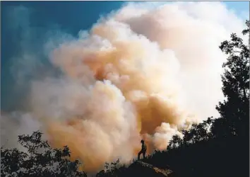  ?? Luis Sinco Los Angeles Times ?? WHAT ARE you personally willing to sacrifice to bring about a safe climate future? Bigger wildfires are one consequenc­e of climate change. Above, the Dixie fire burns through terrain near Janesville, Calif., in 2021.