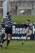  ??  ?? Oisin Lennon clears the danger for Greystones.