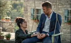  ??  ?? Desperatel­y wanting to become a mother, Sonia Kincaid (Salma Hayek) begins to act maternally toward Michael Bryce (Ryan Reynolds) in “The Hitman’s Wife’s