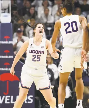  ?? Jessica Hill / Associated Press ?? UConn’s Kyla Irwin (25) and Olivia NelsonOdod­a celebrate in the first half against Notre Dame in December.