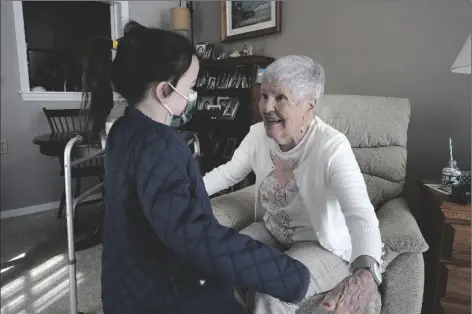  ?? STEVEN SENNE/AP ?? EILEEN QUINN, 98, (RIGHT) A RESIDENT AT NEW POND VILLAGE RETIREMENT COMMUNITY, in Walpole, Mass., greets her greatgrand­daughter Maeve Whitcomb, 6, of Norwood, Mass. (left) Sunday at the retirement community, in Walpole.