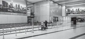  ?? Brian van der Brug / Tribune News Service ?? An airport worker stands in a nearly empty Transporta­tion Security Administra­tion pre-checkpoint line at Los Angeles Internatio­nal Airport on Saturday.