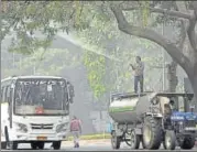  ?? PTI ?? An NDMC worker sprays water on a tree on Monday.
