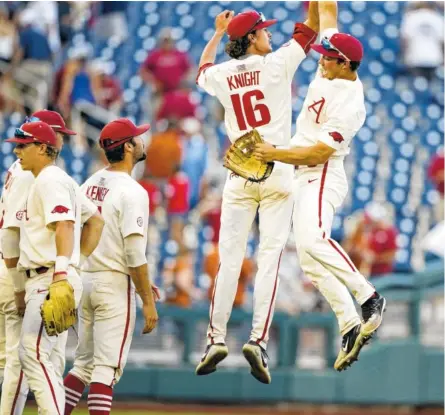  ?? THE ASSOCIATED PRESS ?? Arkansas pitcher Blaine Knight and center fielder Dominic Fletcher celebrate after Sunday’s 11-5 victory over Texas in the College World Series in Omaha, Neb.