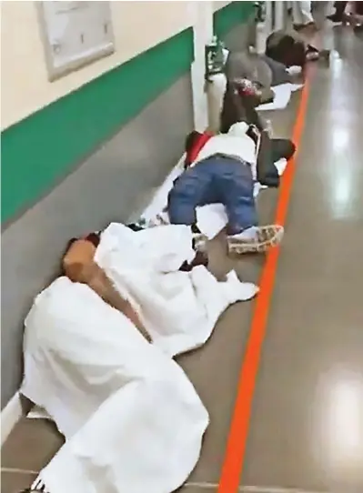  ??  ?? Gasping for air: The sick lying on the floor of the Infanta Leonor hospital in Madrid