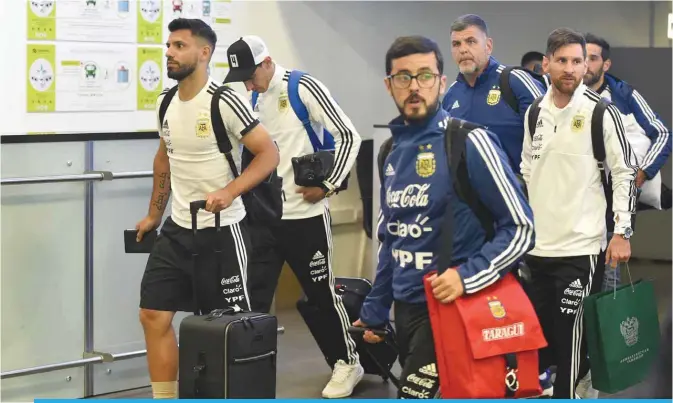  ??  ?? MOSCOW: Argentina’s forward Lionel Messi (R) and team mates walk at the Zhukovsky airport, near Moscow, as Argentina’s national football team arrives ahead of the Russia 2018 World Cup. — AFP