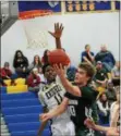  ?? MICHAEL REEVES — FOR DIGITAL FIRST MEDIA ?? Bishop Shanahan’s Kevin Dodds tries to squeeze in a layup between the Rustin defense Saturday night.