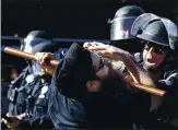  ?? BEN MARGOT — THE ASSOCIATED PRESS ?? David Baca is hit with a police baton before he was taken to the ground during the first day of George Floyd protests in downtown San Jose on May 29.