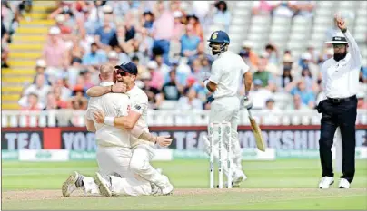  ?? PTI ?? LONE CRUSADER: England’s James Anderson and Ben Stokes celebrate after dismissing Indian captain Virat Kohli in the first Test at Edgbaston, Birmingham