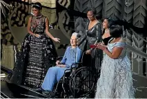  ??  ?? Taraji P. Henson , Octavia Spencer, right, Janelle Monae, left, and Katherine Johnson (in wheelchair) present for Best Documentar­y Feature.