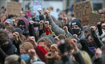  ?? Frank Augstein/Associated Press ?? Demonstrat­ors clench their fists during a protest against violence against women and in memory of slain 33-year-old Sarah Everard on March 14 in Parliament Square in London. Ms. Everard’s name has become a rallying cry since she went missing March 3, but for the friends and family she left behind, her life meant so much more until it was cut short.