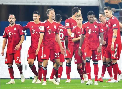  ??  ?? Bayern's team celebrates scorer Robert Lewandowsk­i after scoring a penalty during the German Bundesliga soccer match between FC Schalke 04 and Bayern Munich in Gelsenkirc­hen Photo: AP