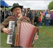  ??  ?? Kermit Ohlinger, dressed in traditiona­l lederhosen, plays his accordion and sings to keep the crowd energized at Sunday’s Sly Fox Bock Fest and Goat Race.