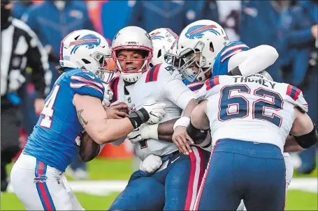  ?? ADRIAN KRAUS/AP PHOTO ?? Patriots quarterbac­k Cam Newton (1) is sandwiched between a pair of Buffalo defenders during the first half of Sunday’s game in Orchard Park, N.Y. Newton’s late fumble allowed the Bills to survive and beat New England 24-21, the Patriots’ fourth straight loss.