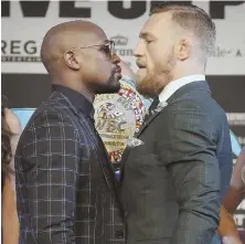  ?? AP PHOTO ?? READY TO FACE OFF: Floyd Mayweather Jr. (left) and Conor McGregor stare each other down during yesterday’s press conference in Las Vegas.