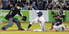  ?? Fred Thornhill ?? The Associated Press Umpire Ed Hickox calls out Kevin Pillar after a tag by Red Sox third baseman Eduardo Nunez in the ninth inning of the Blue Jays’ 5-3, 12-inning win Friday at Rogers Centre.