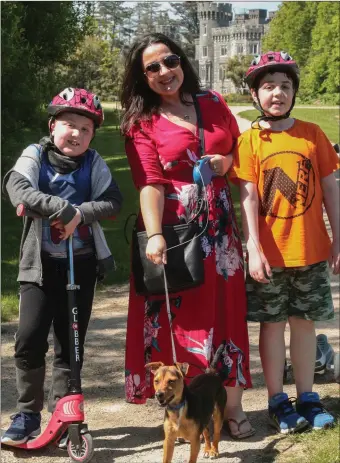  ??  ?? Luke Taylor, Abbie Elfouly and Isaac Taylor, and their dog Chase enjoying a sunny day in Johnstown Castle on Wednesday.