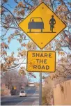  ?? EDDIE MOORE/JOURNAL ?? “Share the Road” signs in Santa Fe, like this one on Galisteo Street, would be replaced with signs that say “Bicycles May Use Full Lane” if the City Council approves a resolution introduced by City Councilor JoAnne Vigil Coppler.