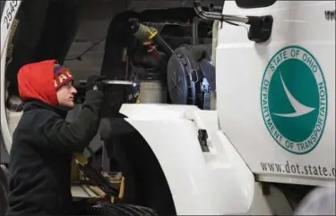  ?? ERIC BONZAR — THE MORNING JOURNAL ?? Jarett Williams, temporary seasonal help for the Ohio Department of Transporta­tion (ODOT) District Three, inspects under the hood of a snow plow truck Oct. 31. ODOT held its Operationa­l Readiness Inspection­s, which included a 150-point check of all its...