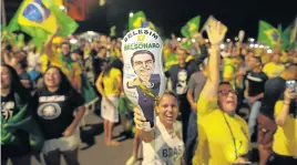  ?? Picture: AFP/SERGIO LIMA ?? EUPHORIC: Supporters of presidenti­al candidate Jair Bolsonaro, celebrate in front of the National Congress in Brasilia, after the former army captain won Brazil's presidenti­al election, on Sunday.