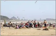  ?? LAURA DICKINSON — THE TRIBUNE ?? Crowds pack the beach in Pismo Beach on Saturday. Many were not using proper social distance, but a few were wearing masks.