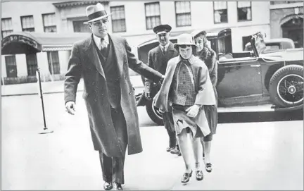  ?? Associated Press ?? ‘POOR LITTLE RICH GIRL’ Gloria Vanderbilt, accompanie­d by a bodyguard, chauffeur and nurse, enters the home of her mother, Gloria Morgan Vanderbilt, in Midtown Manhattan for an Easter weekend visit in April 1935. Her mother and an aunt fought over her custody in a 1934 trial.