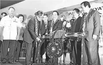  ??  ?? Abang Johari beating the gong to officiate at the United People’s Party (UPP) extraordin­ary delegates’ conference in Kuching yesterday.
