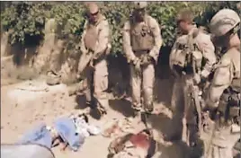  ?? Associated Press ?? AN IMAGE from a video posted on the Internet shows four men in Marine combat gear standing over corpses. Pentagon officials say all four have been identified.